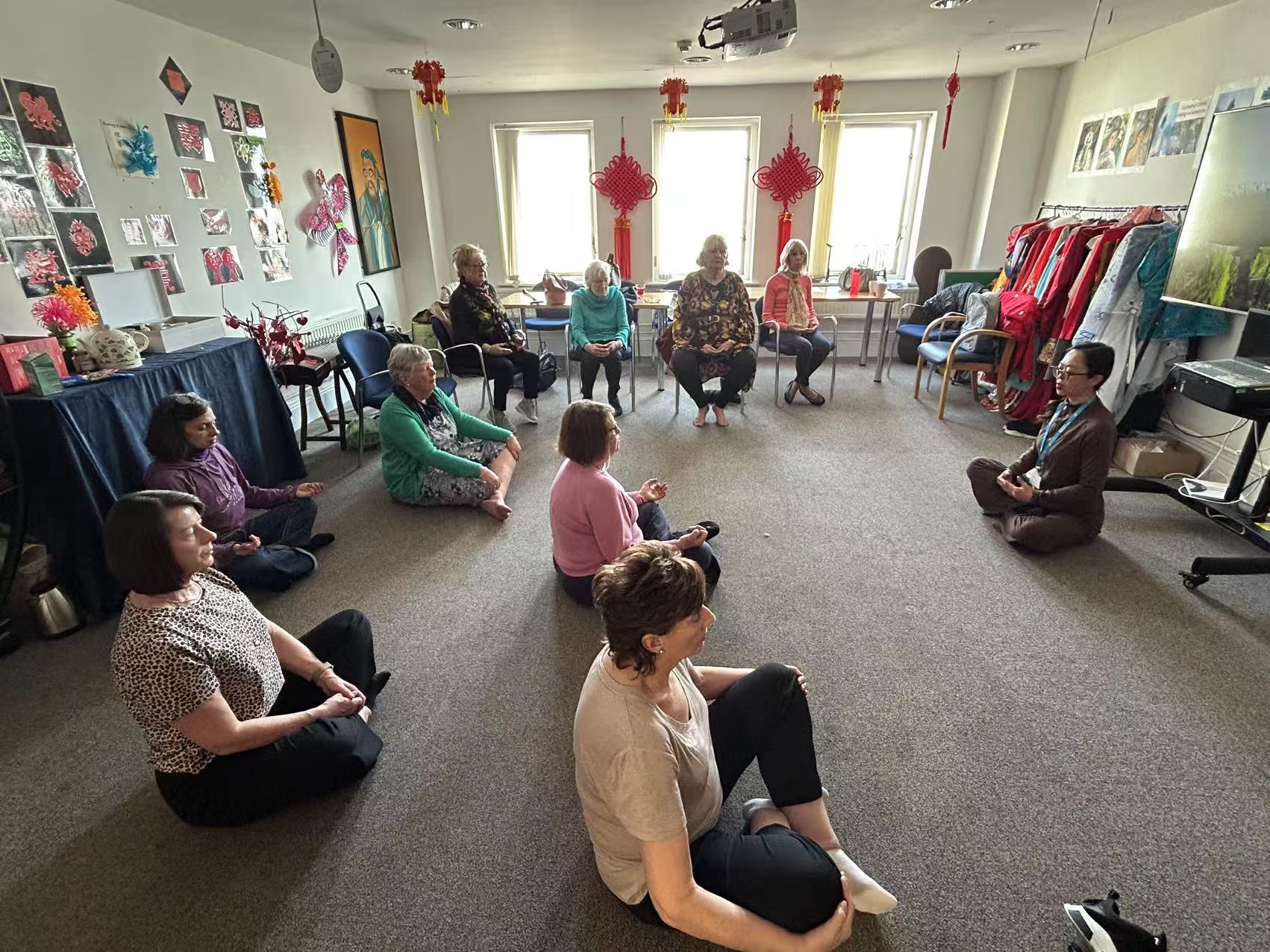 A community group practising seated meditation and mindful movement with Dr Jar