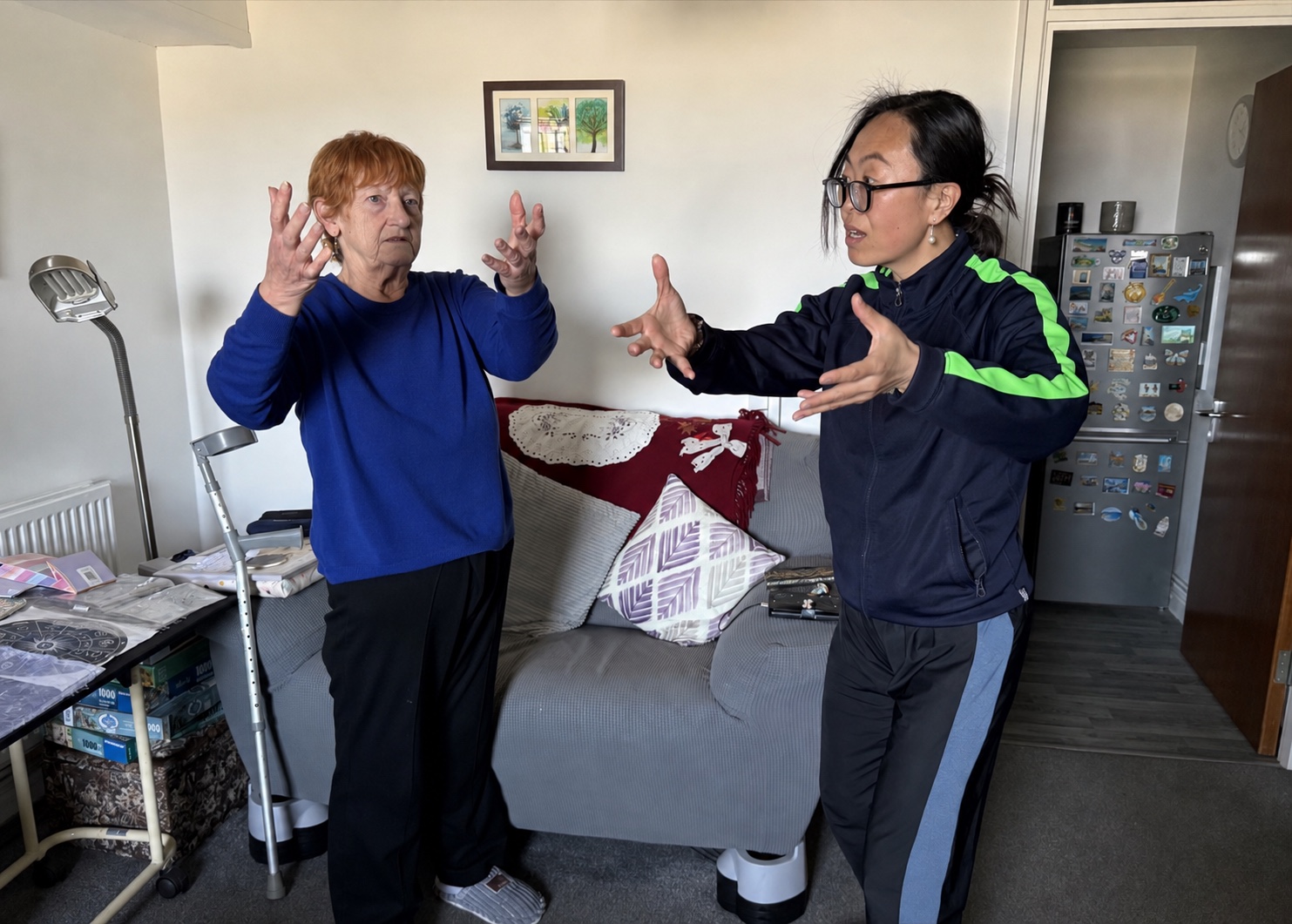 Dr Jar guiding a client through one-to-one Tai Chi in her home