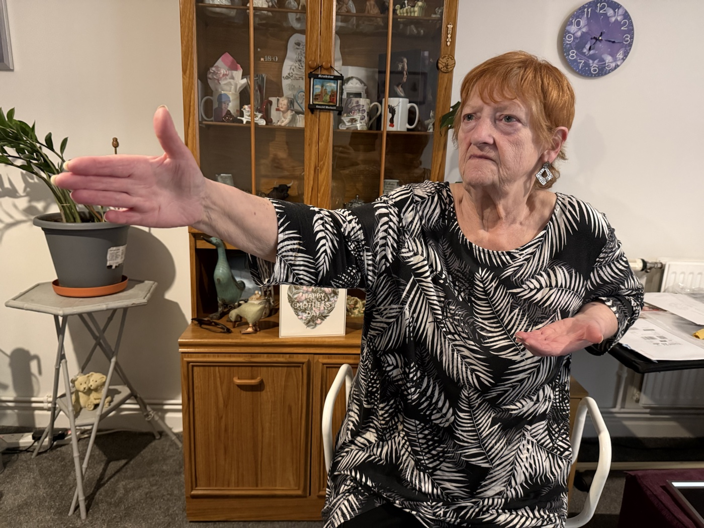 A client practising a guided Tai Chi movement in her home