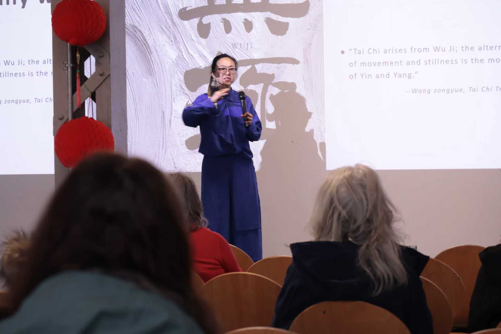 Dr Jar speaking to an audience during a Tai Chi and Daoist wellbeing event